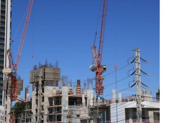 High-rise building under construction with a tower crane
