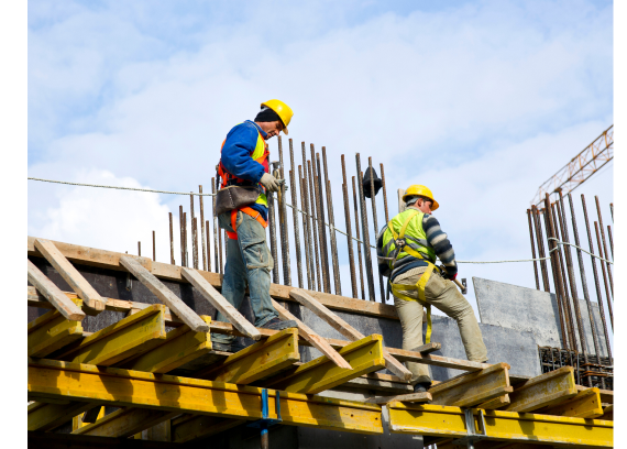 Workers assembling rebar formwork on site