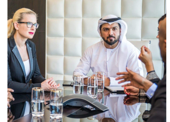 Compliance discussion around a meeting table